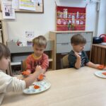 Dzieci malują dłonie. Współpraca w parach.